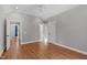 Bedroom with hardwood floors, ceiling fan, closet and doorway to stairs at 4905 Ivercroft Pl, Fuquay Varina, NC 27526