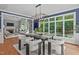 Dining room with large windows overlooking the backyard and contemporary lighting at 4905 Ivercroft Pl, Fuquay Varina, NC 27526