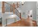 Staircase featuring hardwood steps and wrought iron railings, with an entry way in the background at 4905 Ivercroft Pl, Fuquay Varina, NC 27526