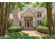 Charming brick house with a red front door framed by lush landscaping at 4905 Ivercroft Pl, Fuquay Varina, NC 27526