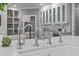 Close-up of kitchen island with a farmhouse sink and stainless steel faucets at 4905 Ivercroft Pl, Fuquay Varina, NC 27526