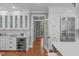 Bright kitchen features white cabinetry, stainless steel appliances, and a wine cooler for modern convenience at 4905 Ivercroft Pl, Fuquay Varina, NC 27526