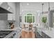 Open kitchen with stainless steel appliances and a breakfast area with a large window at 4905 Ivercroft Pl, Fuquay Varina, NC 27526