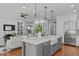 Open kitchen with a large island, farmhouse sink, and view to the living room at 4905 Ivercroft Pl, Fuquay Varina, NC 27526