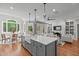 Open concept kitchen with granite counters, stainless appliances, eat-in table, and views to the Gathering room at 4905 Ivercroft Pl, Fuquay Varina, NC 27526