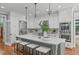 Bright kitchen featuring a large island with seating, stainless steel appliances, and modern lighting at 4905 Ivercroft Pl, Fuquay Varina, NC 27526