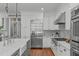 Kitchen with stainless steel appliances, a large refrigerator, and modern white cabinets at 4905 Ivercroft Pl, Fuquay Varina, NC 27526