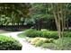 Beautiful winding driveway lined with verdant landscaping at 4905 Ivercroft Pl, Fuquay Varina, NC 27526