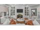 Gathering room with white brick fireplace, large screen TV, built-in shelves, and comfortable seating at 4905 Ivercroft Pl, Fuquay Varina, NC 27526