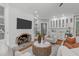 Gathering room with white brick fireplace, large screen TV, built-in shelves, and wet bar at 4905 Ivercroft Pl, Fuquay Varina, NC 27526