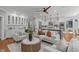 Gathering room with fireplace, ceiling fan, wet bar, views to the kitchen, and comfortable seating at 4905 Ivercroft Pl, Fuquay Varina, NC 27526