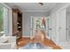 Inviting living room with hardwood floors, french doors, and built-in shelving creating a welcoming space at 4905 Ivercroft Pl, Fuquay Varina, NC 27526