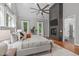 Main bedroom boasts a dark stone fireplace and large windows offering plenty of natural light at 4905 Ivercroft Pl, Fuquay Varina, NC 27526