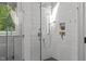 Modern shower featuring glass enclosure, dual shower heads, and tiled walls for a spa-like experience at 4905 Ivercroft Pl, Fuquay Varina, NC 27526