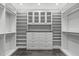 Spacious walk-in closet with custom shelving, drawers, and glass-front cabinets providing ample storage space at 4905 Ivercroft Pl, Fuquay Varina, NC 27526