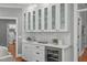 Wet bar features modern lighting, granite counters, beverage fridge, tile backsplash, and plenty of storage at 4905 Ivercroft Pl, Fuquay Varina, NC 27526
