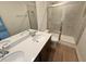 Bathroom features double sinks, hard surface countertops, and glass-enclosed shower at 507 Eastwood St, Durham, NC 27704