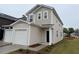 A modern townhome with a single-car garage and neutral siding stands on a well-maintained lawn at 507 Eastwood St, Durham, NC 27704