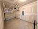 Garage with garage door, garage door opener, and unfinished drywall at 507 Eastwood St, Durham, NC 27704