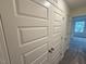 Hallway featuring storage closet and neutral carpet at 507 Eastwood St, Durham, NC 27704