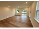 Bright and airy living room with wood-look floors and sliding glass doors to the outdoor area at 507 Eastwood St, Durham, NC 27704