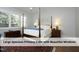 Cozy primary suite with a four-poster bed and bright, shuttered windows at 511 Hillsborough St # Bldg B 106, Chapel Hill, NC 27514