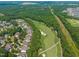 Aerial view of homes along the golf course, showing picturesque community and landscape at 521 Morning Oaks Dr, Holly Springs, NC 27540