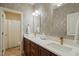 Bathroom showcasing dual sinks with quartz countertops and modern bronze fixtures at 521 Morning Oaks Dr, Holly Springs, NC 27540