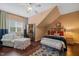 A comfortable bedroom with an angled ceiling and a cushioned seating area at 521 Morning Oaks Dr, Holly Springs, NC 27540