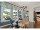 Cozy dining room with large windows offering a view of the lush outdoor living space and natural light at 521 Morning Oaks Dr, Holly Springs, NC 27540
