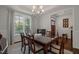 Elegant dining room with a large table, stylish chairs, and ample natural light, perfect for hosting gatherings at 521 Morning Oaks Dr, Holly Springs, NC 27540