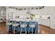 Bright kitchen featuring an oversized island, white cabinets, and stainless steel appliances, ideal for cooking and entertaining at 521 Morning Oaks Dr, Holly Springs, NC 27540