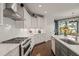 Well-appointed kitchen with stainless steel appliances, an island, and granite countertops overlooks a sunny breakfast nook at 521 Morning Oaks Dr, Holly Springs, NC 27540