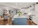 Bright, updated kitchen with a central island, stainless steel appliances, and a seamless flow to the living areas at 521 Morning Oaks Dr, Holly Springs, NC 27540