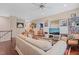 Comfortable living room with wood floors, ceiling fan and ample seating at 521 Morning Oaks Dr, Holly Springs, NC 27540