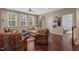 Bright living room featuring hardwood floors, plenty of natural light, and cozy seating at 521 Morning Oaks Dr, Holly Springs, NC 27540