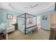 Comfortable bedroom features a four-poster bed, ceiling fan, and adjoining bathroom at 521 Morning Oaks Dr, Holly Springs, NC 27540