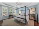 Elegant bedroom featuring a four-poster bed, trey ceilings, and plenty of natural light at 521 Morning Oaks Dr, Holly Springs, NC 27540