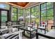 Bright and airy sunroom with comfortable seating and panoramic views of the well-manicured backyard and greenery at 521 Morning Oaks Dr, Holly Springs, NC 27540