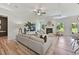 Bright living room featuring a fireplace, ample seating, and a ceiling fan, perfect for relaxation and entertaining at 522 Olivia Crossing Ct # 18, Four Oaks, NC 27524