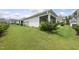 View of the backyard showing the lawn, landscaping, and rear exterior of the house at 537 Bramble Ln, Clayton, NC 27527