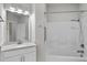 Bright bathroom with a white vanity, a framed mirror, and a shower-tub combination at 537 Bramble Ln, Clayton, NC 27527