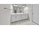 Double sink vanity with marble-look countertops and sleek hardware in this bright bathroom at 537 Bramble Ln, Clayton, NC 27527