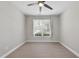Cozy bedroom featuring carpet floors, a ceiling fan, and a bright window with outside views at 537 Bramble Ln, Clayton, NC 27527