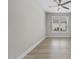 Bright bedroom with light hardwood floors, neutral walls, and a window with blinds at 537 Bramble Ln, Clayton, NC 27527