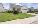 Inviting single-story home featuring a well-kept lawn and a convenient attached garage at 537 Bramble Ln, Clayton, NC 27527