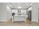 Gourmet kitchen with quartz island, stainless appliances, and white cabinets at 537 Bramble Ln, Clayton, NC 27527
