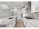 Gourmet kitchen with quartz island, gas cooktop, and custom backsplash at 537 Bramble Ln, Clayton, NC 27527