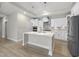 Gourmet kitchen with quartz island, stainless appliances, and white cabinets at 537 Bramble Ln, Clayton, NC 27527