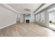 Bright living room with fireplace, ceiling fan, tray ceiling, and hardwood floors at 537 Bramble Ln, Clayton, NC 27527